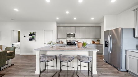A kitchen with a table and chairs.
