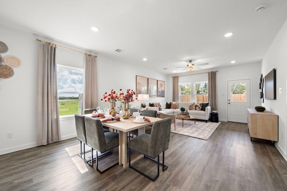 A large living room with a dining table and chairs.