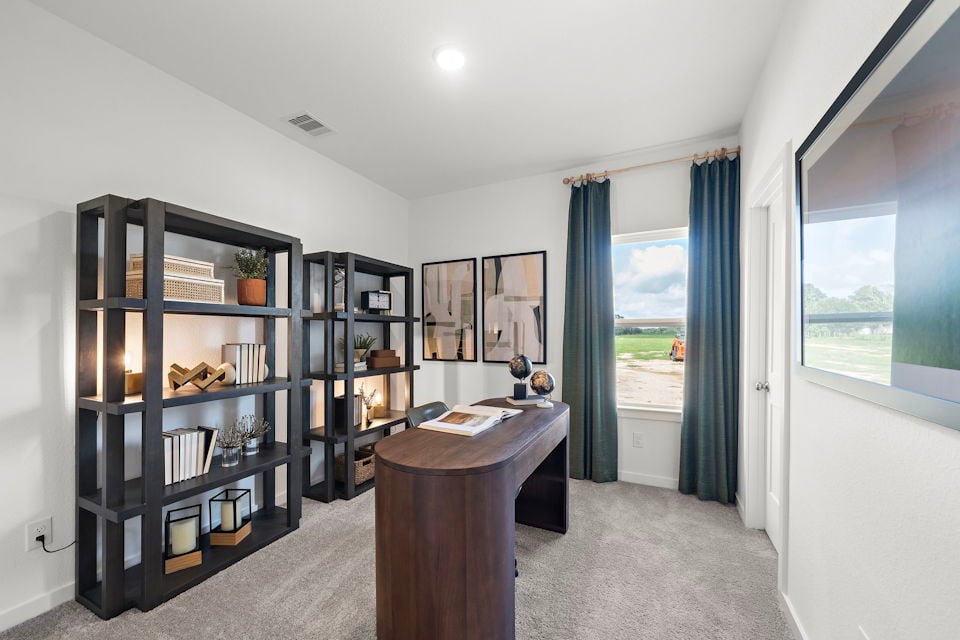 A room with a desk and shelves.