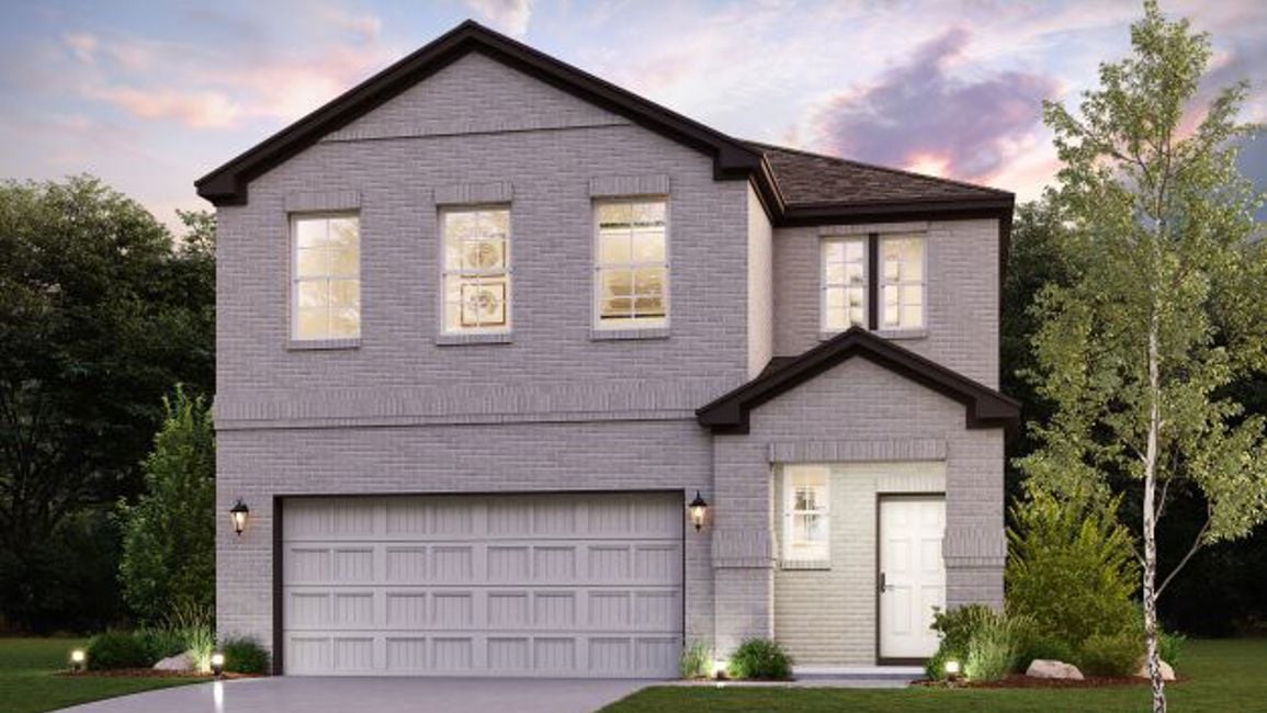A house with a garage and trees.