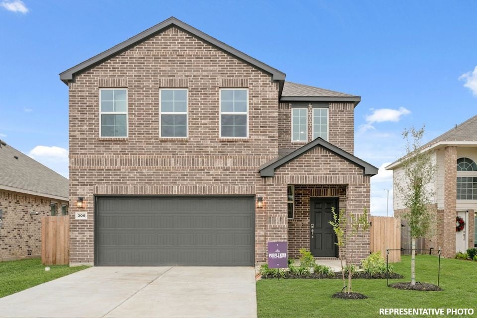 A brick house with a garage.