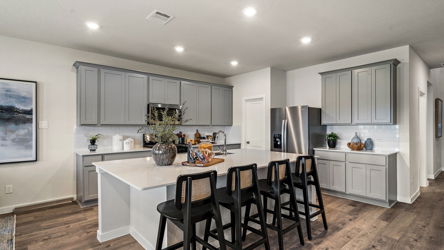 A kitchen with a dining table and chairs.