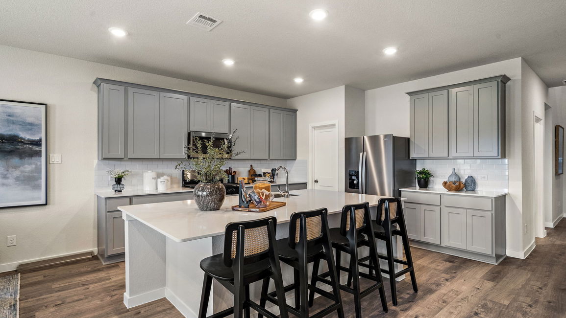 A kitchen with a dining table and chairs.