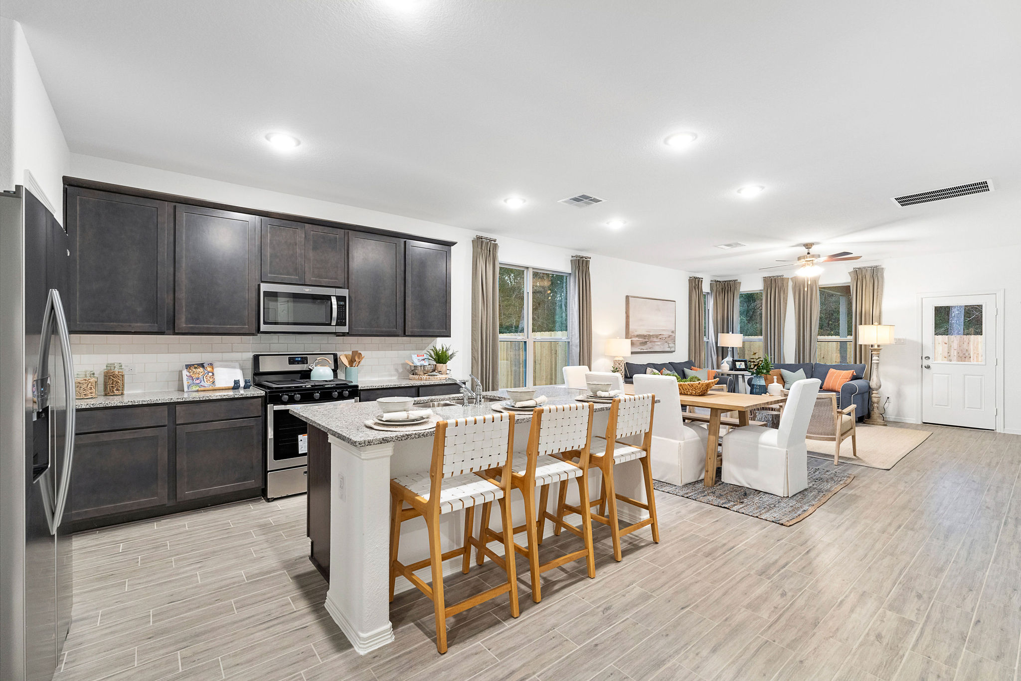 A kitchen with a dining table and chairs.