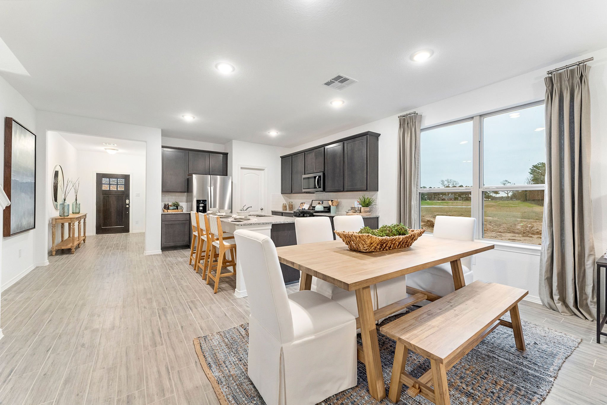 A large kitchen with a dining table.