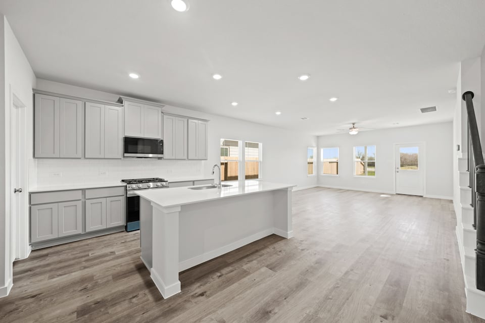 A kitchen with white cabinets.