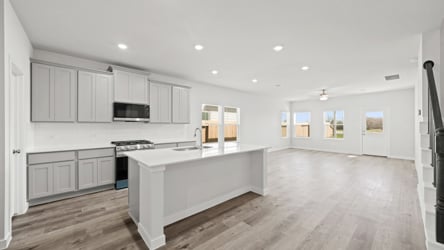 A kitchen with white cabinets.