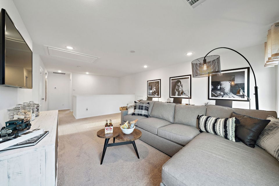 A living room with a couch and a table.