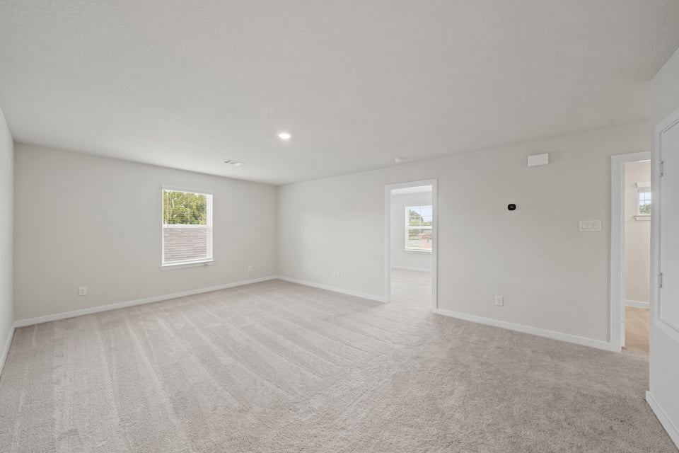 A room with a carpet and a rug.