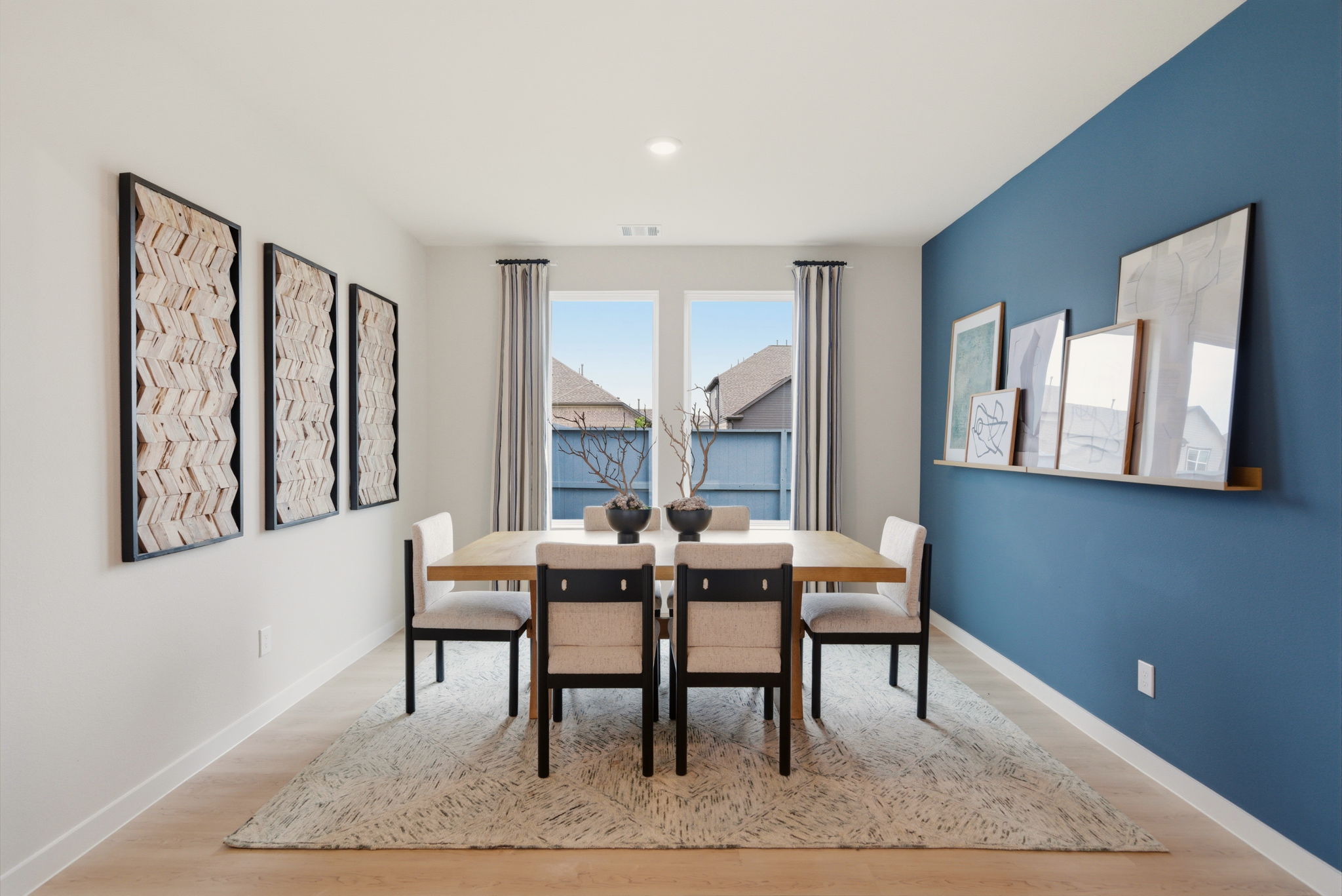 A dining room with a table and chairs.