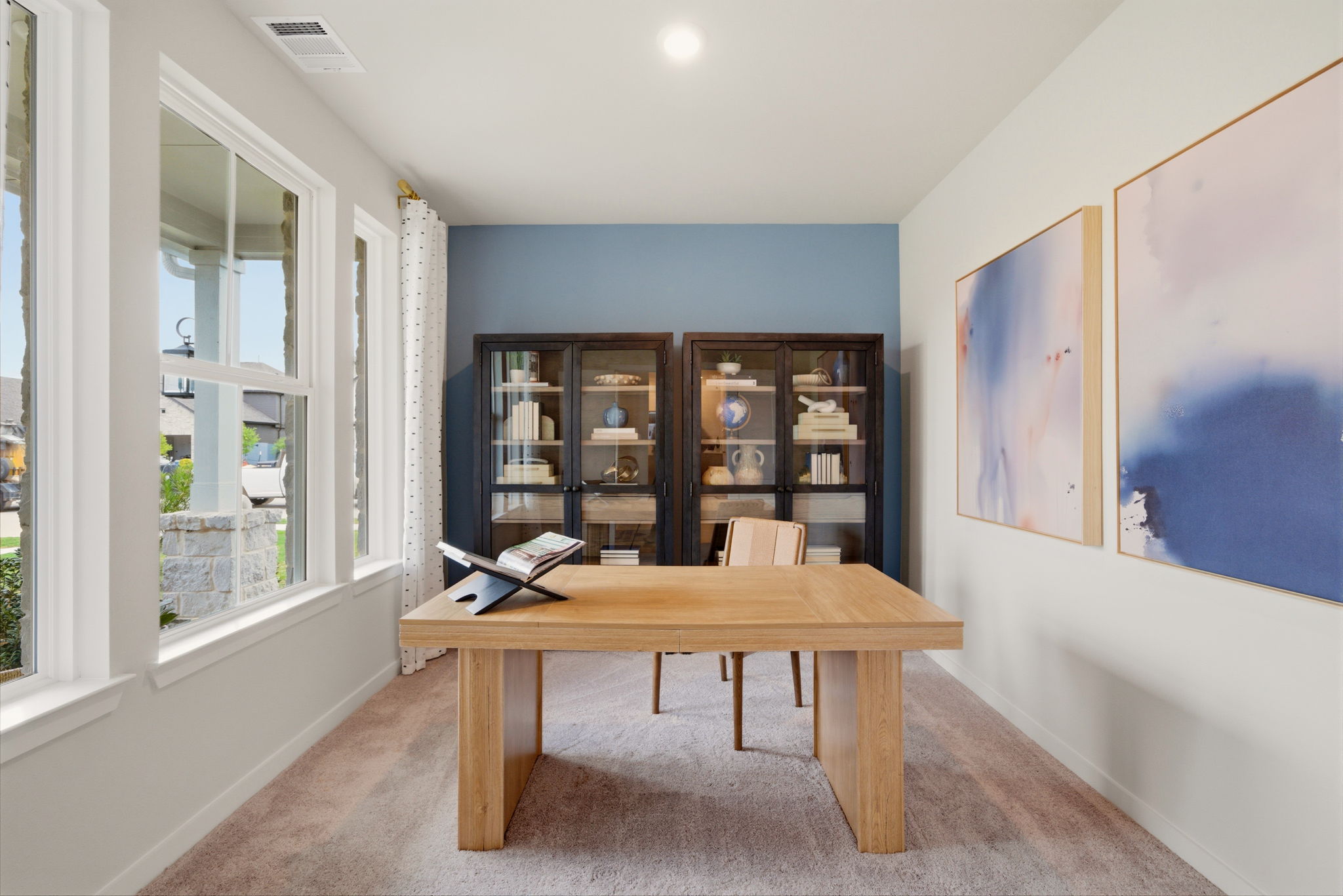 A room with a table and shelves.