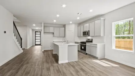 A kitchen with white cabinets.
