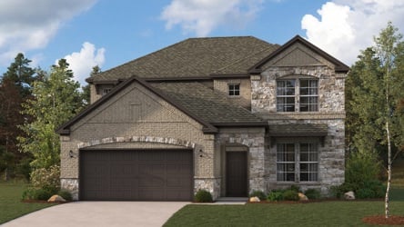 A stone house with a garage.