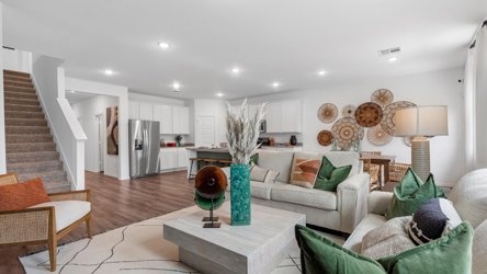 A living room with a staircase.