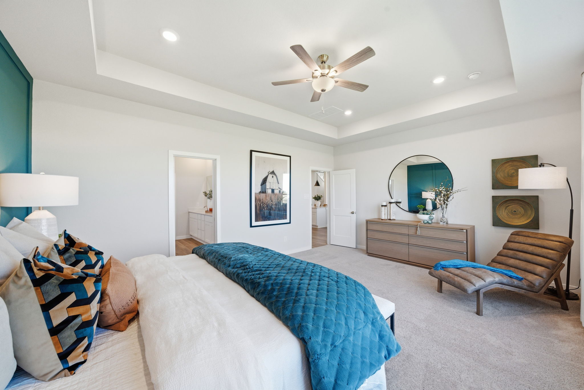 A bedroom with a bed and a fan.