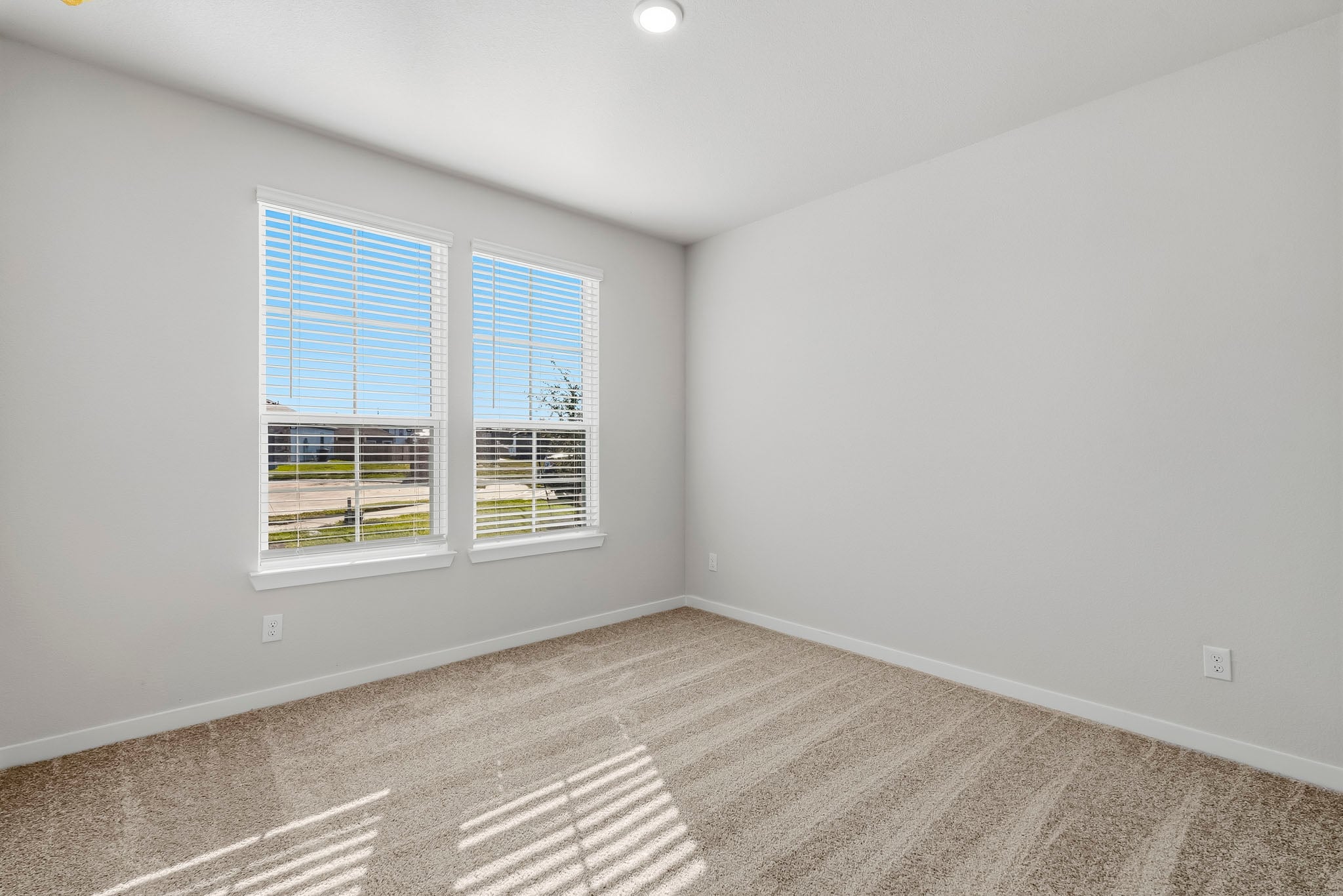 A room with a window and a carpet.