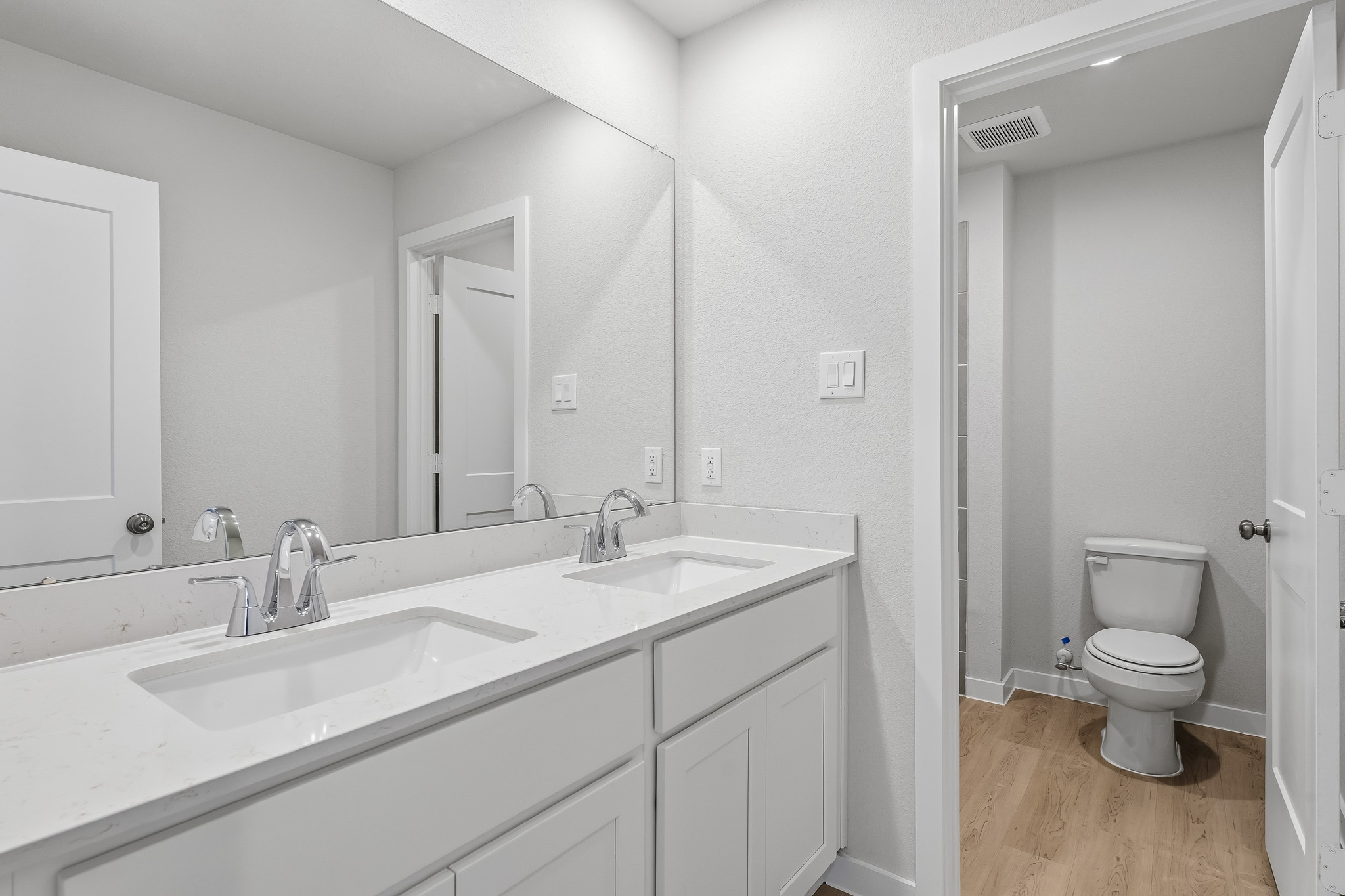 A bathroom with a toilet and sink.
