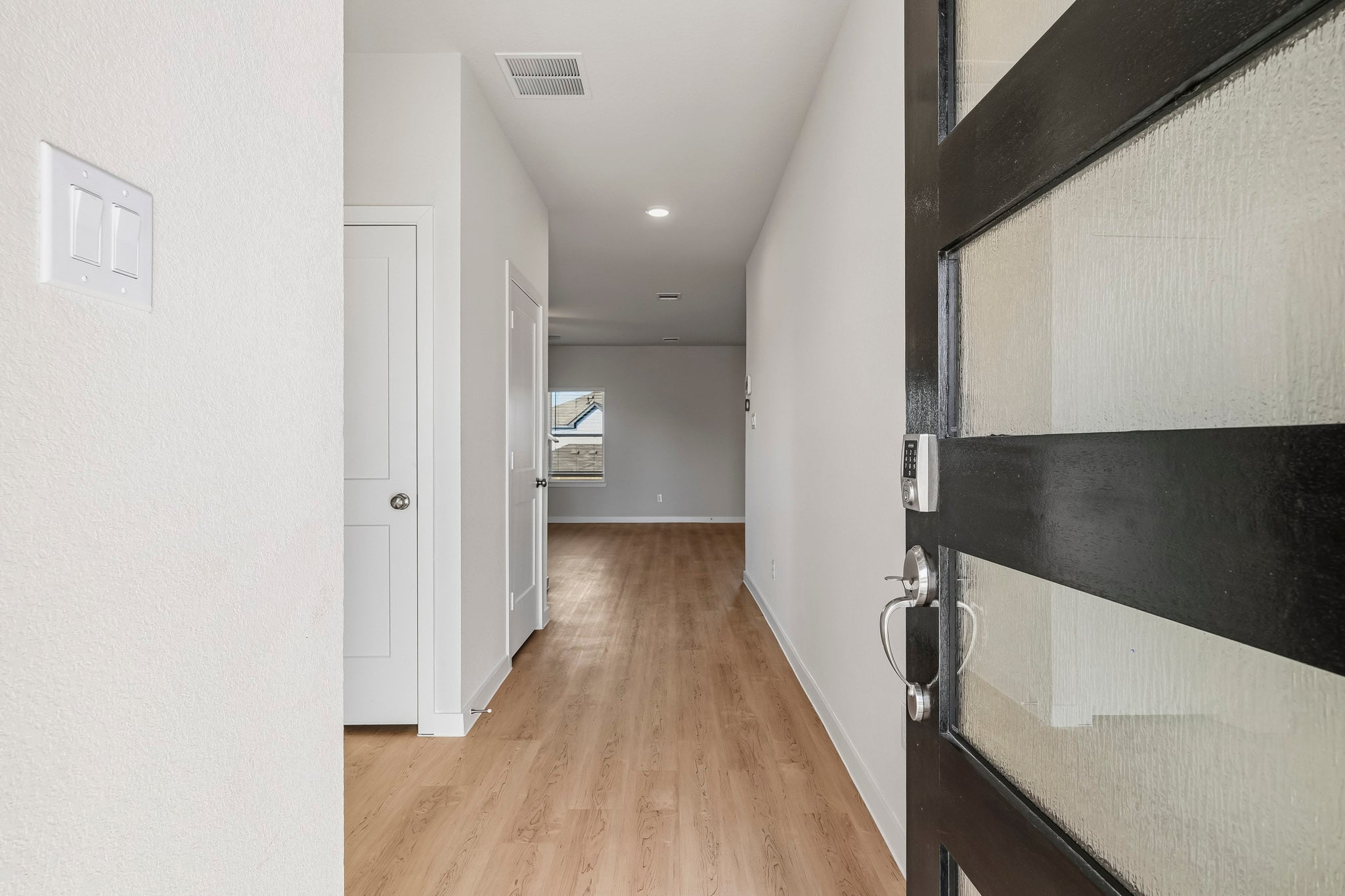 A hallway with black cabinets.