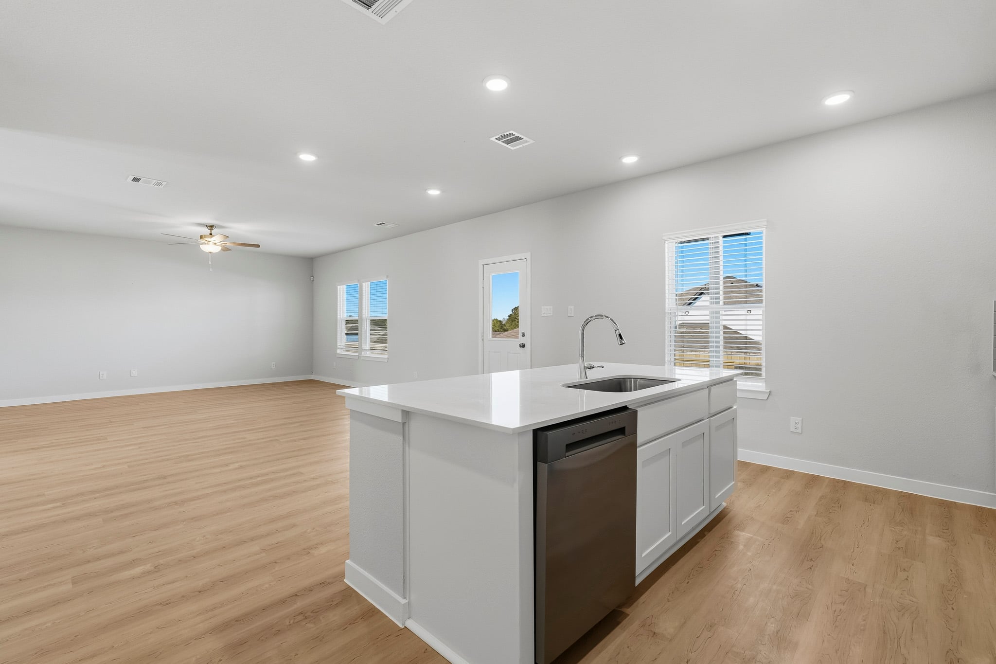 A kitchen with white cabinets.
