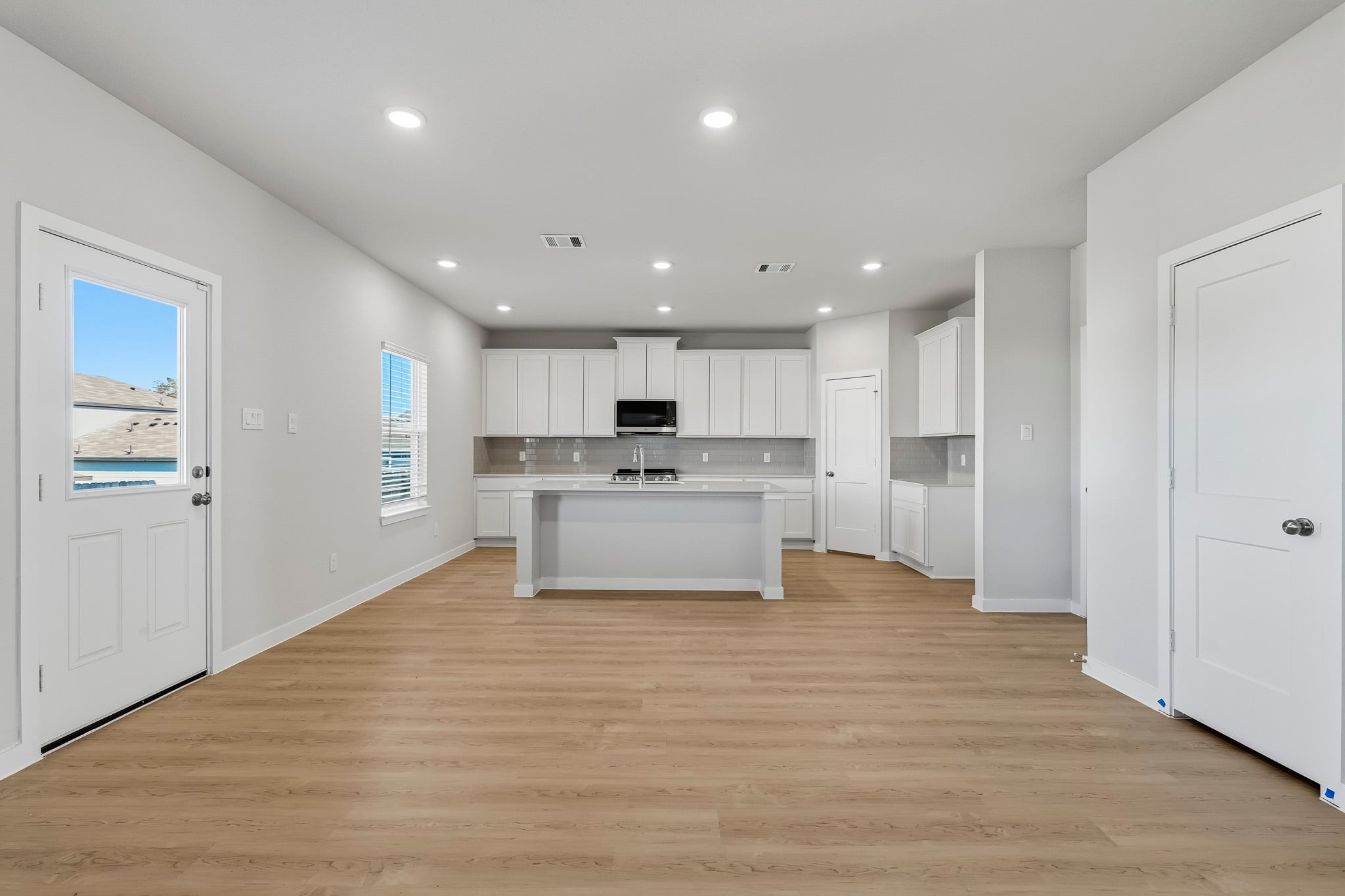 A large kitchen with white cabinets.
