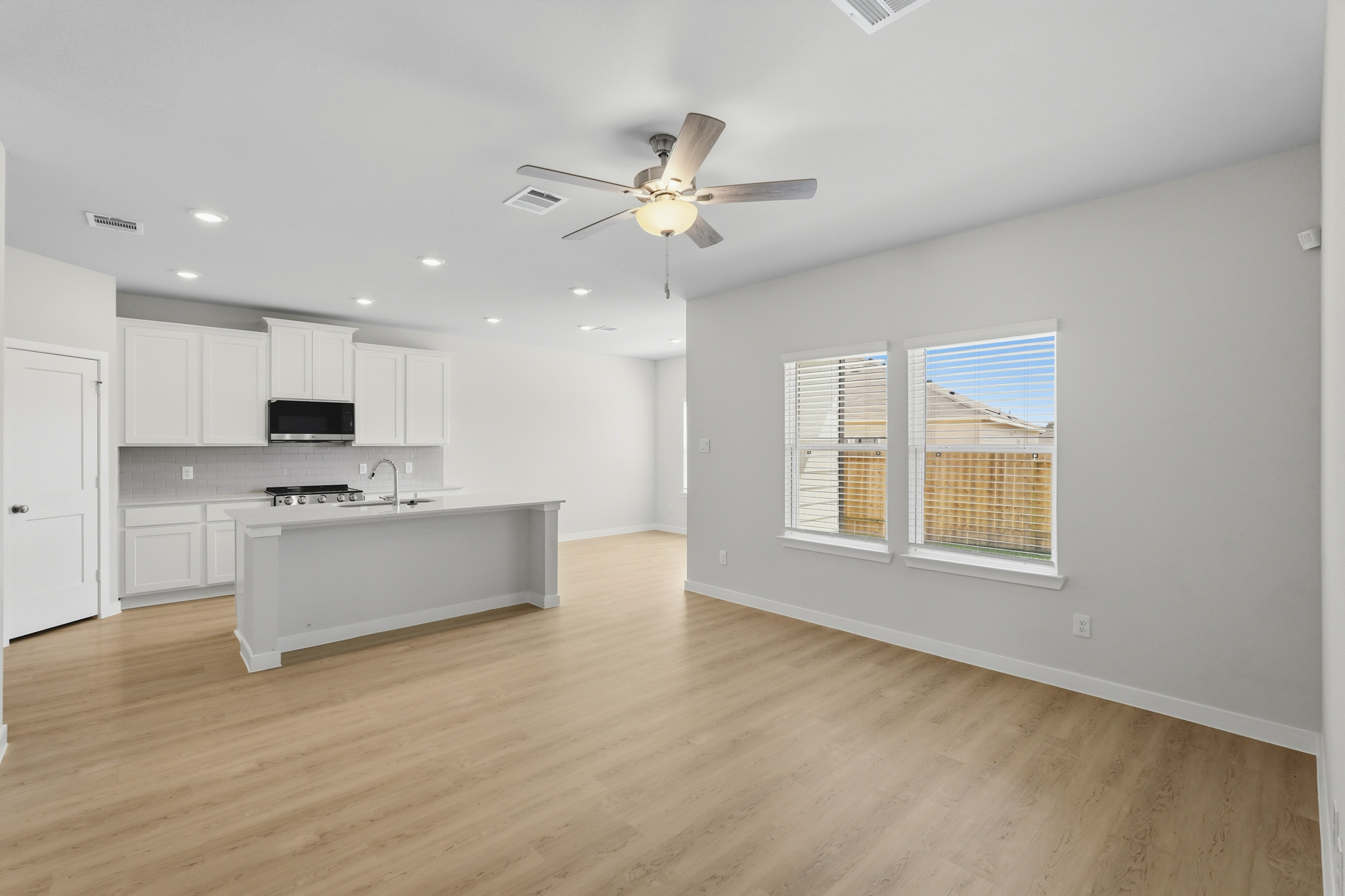 A kitchen with white cabinets.