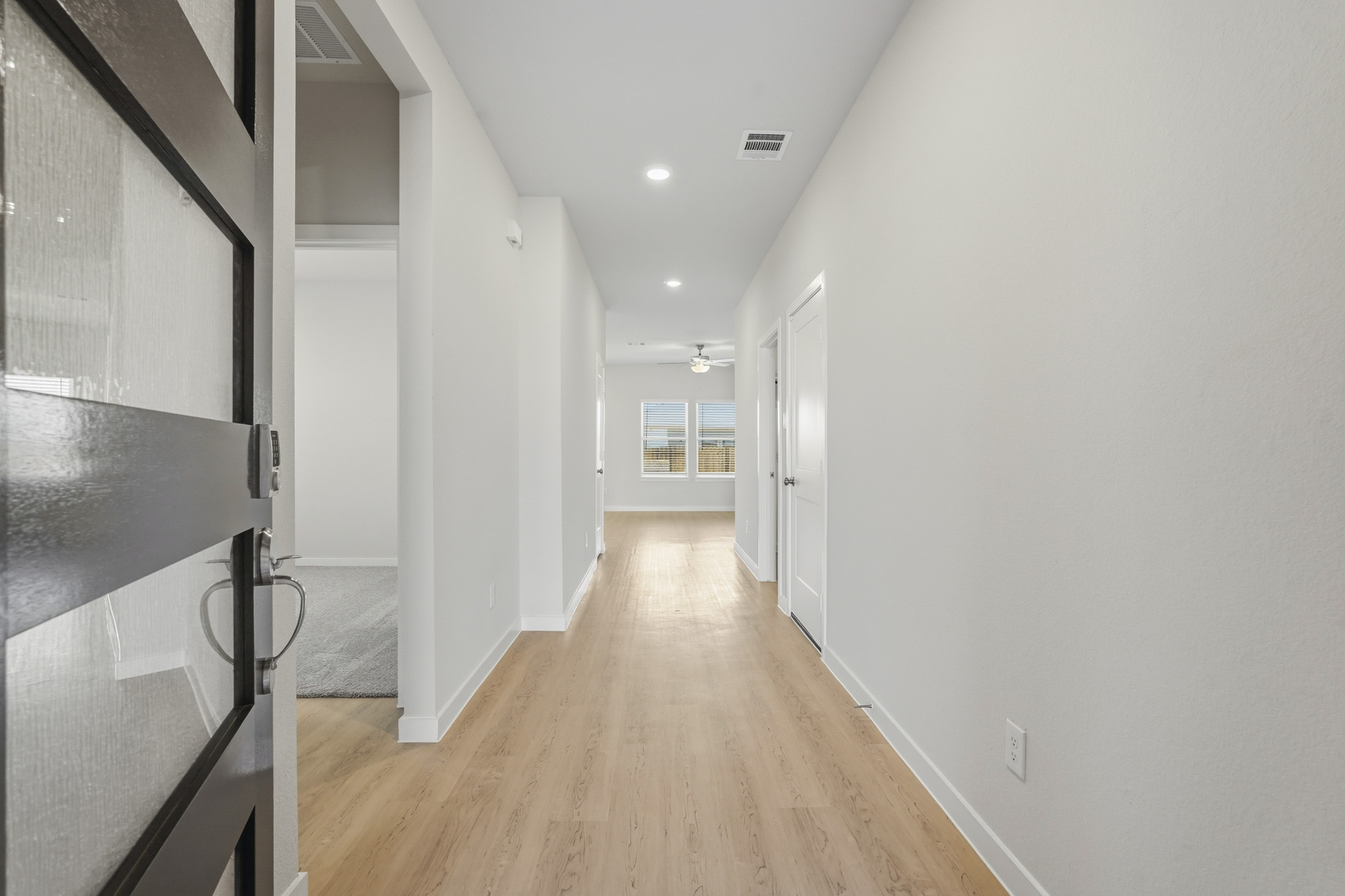 A long hallway with white walls.