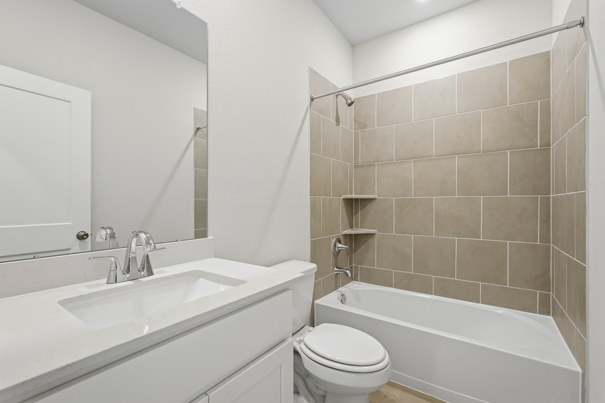 A bathroom with a tub sink and toilet.