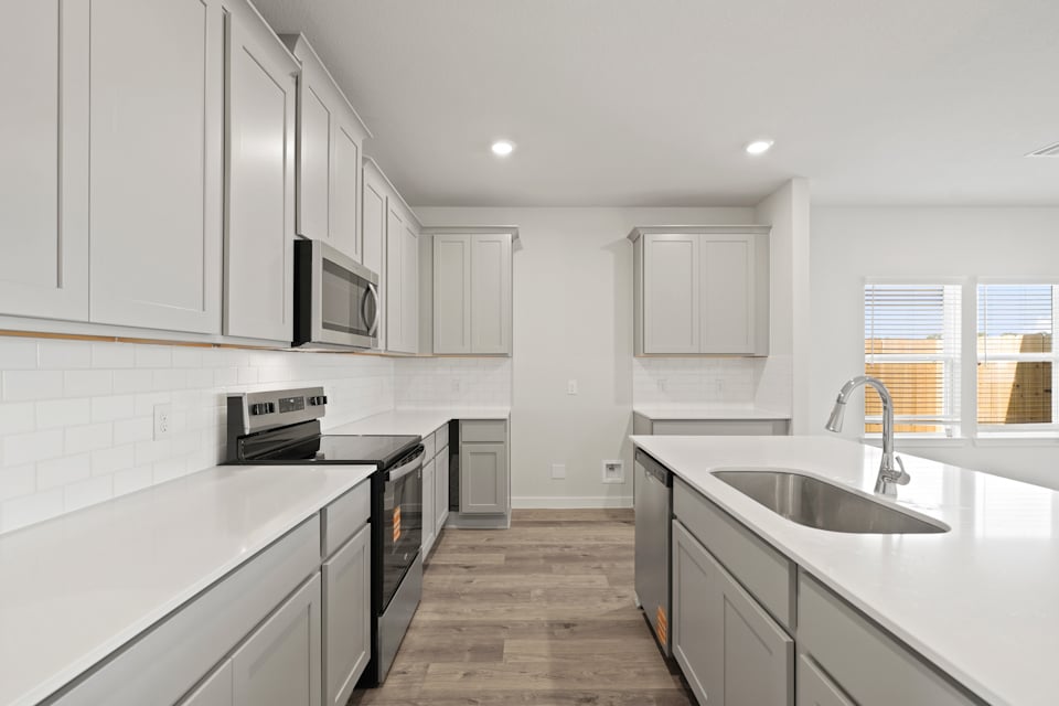 A kitchen with white cabinets.