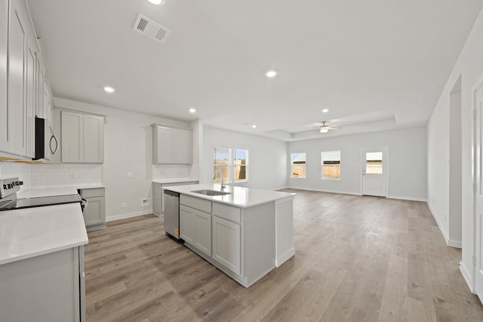 A large kitchen with white cabinets.