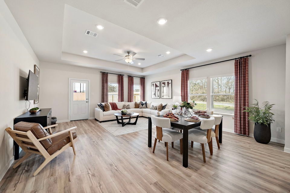 A large living room with a large dining table and chairs.