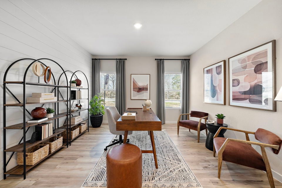 A living room with a table and chairs.