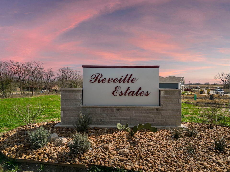A sign on a stone wall.