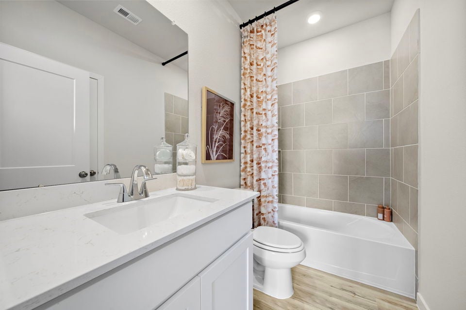 A bathroom with a tub toilet and sink.
