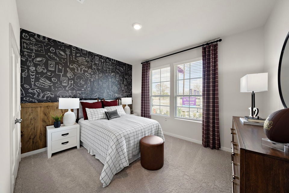 A bedroom with a bed and a window.