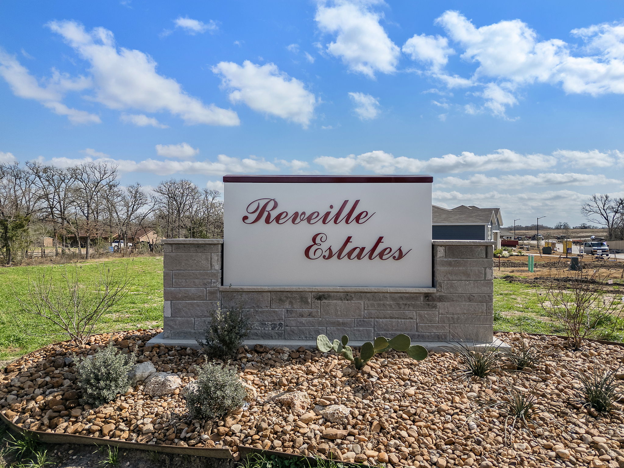 A sign on a stone wall.