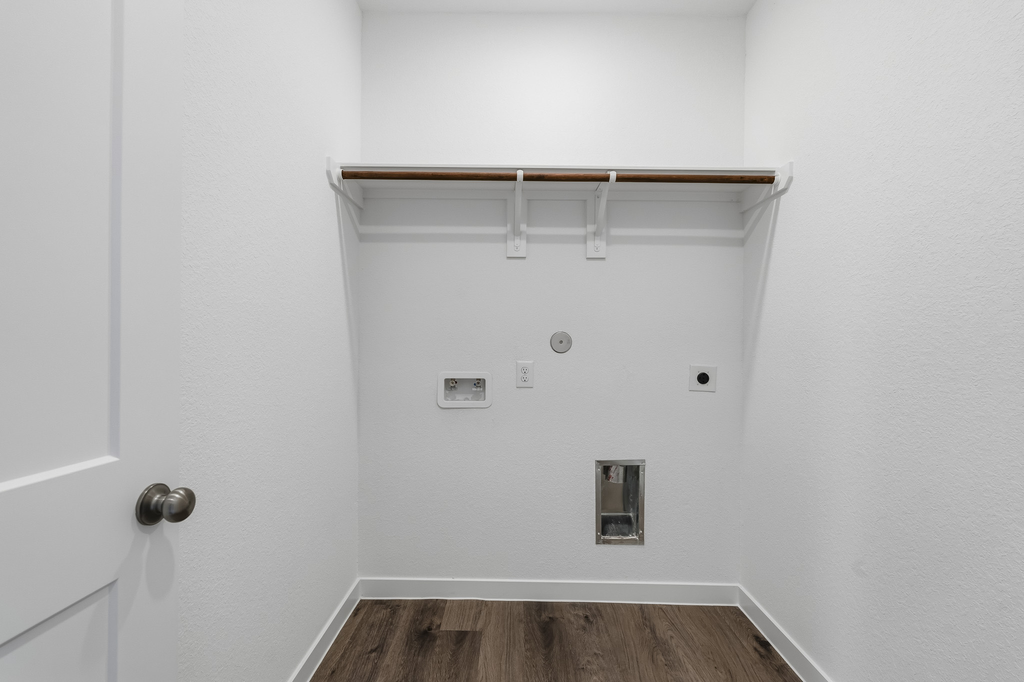 A white wall with a light fixture.