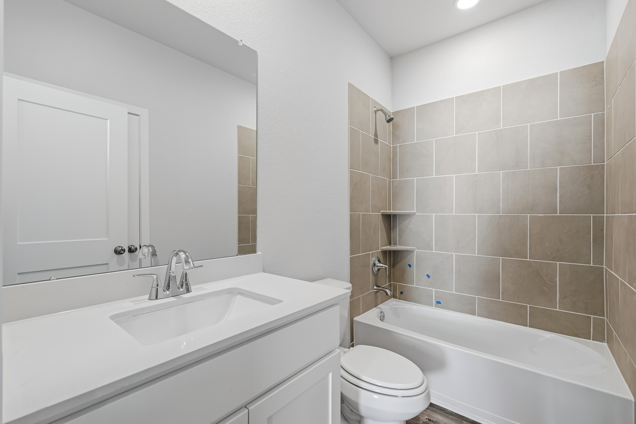 A bathroom with a tub sink and toilet.