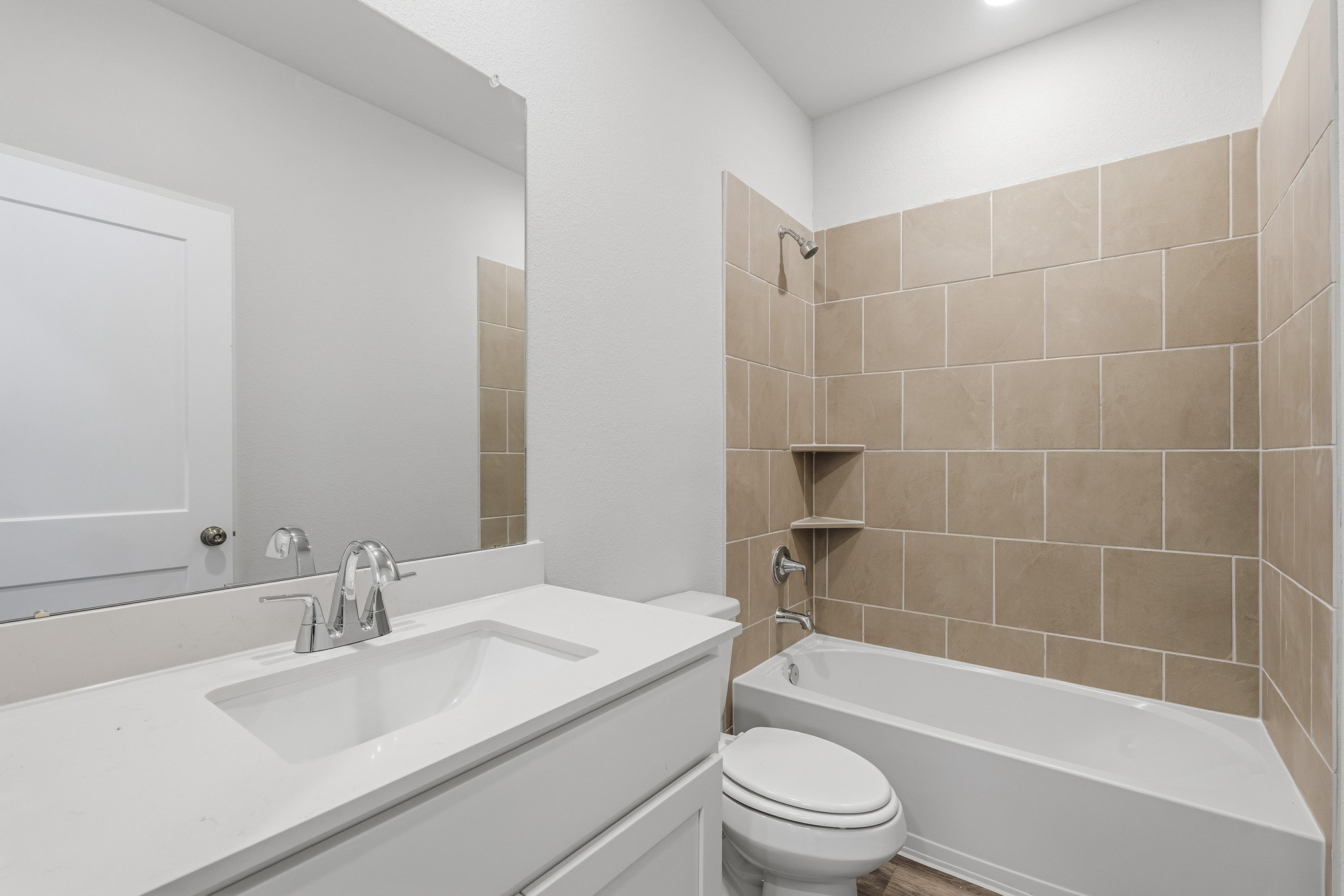 A bathroom with a tub sink and toilet.