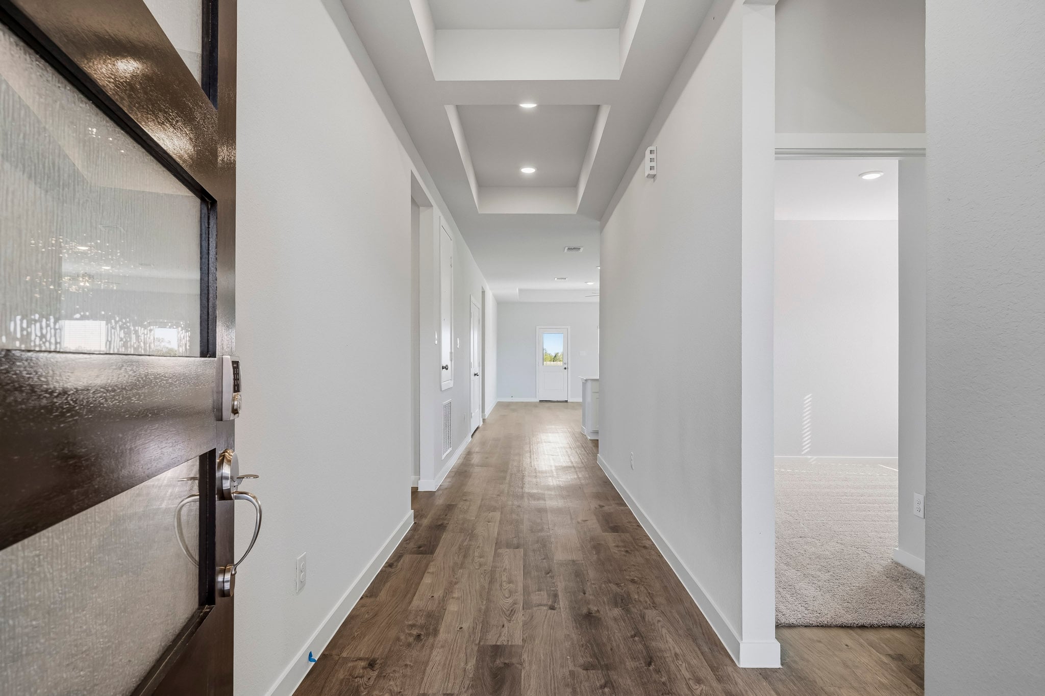 A hallway with white walls.