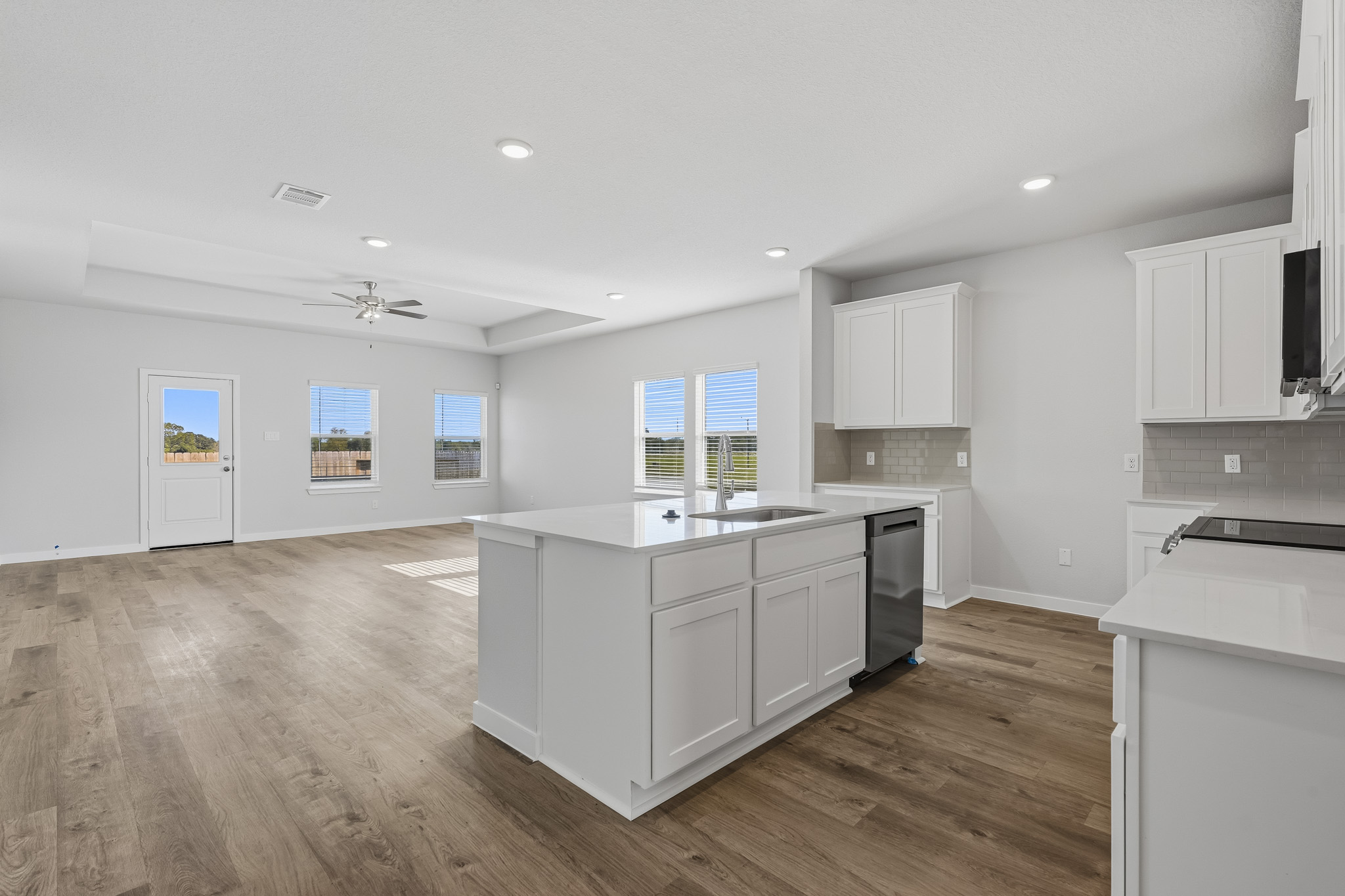 A kitchen with white cabinets.