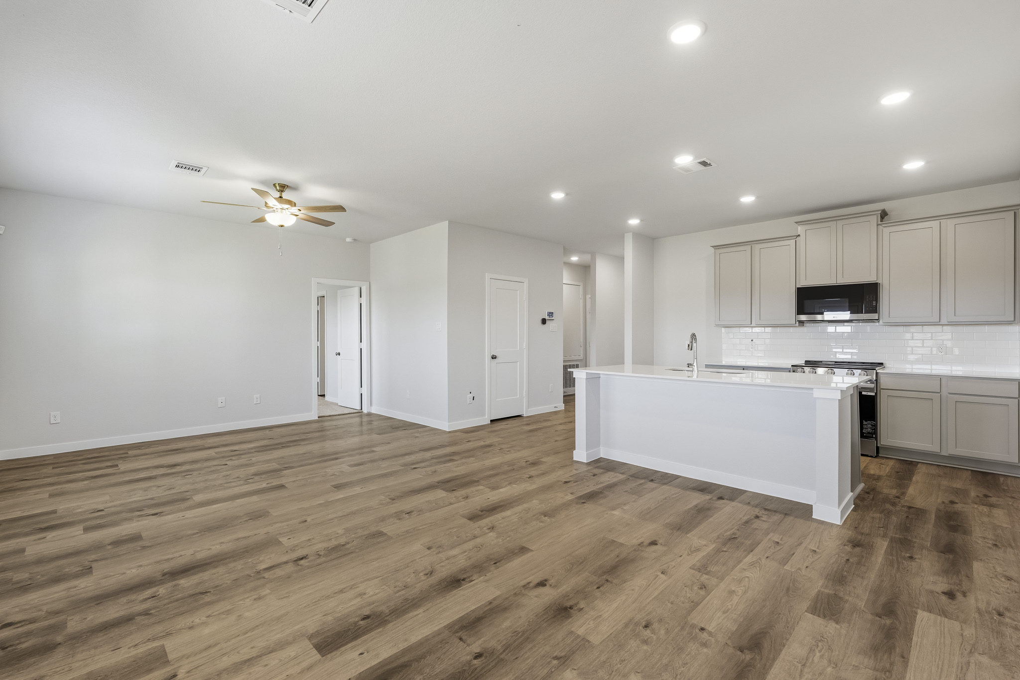 A kitchen with white cabinets.