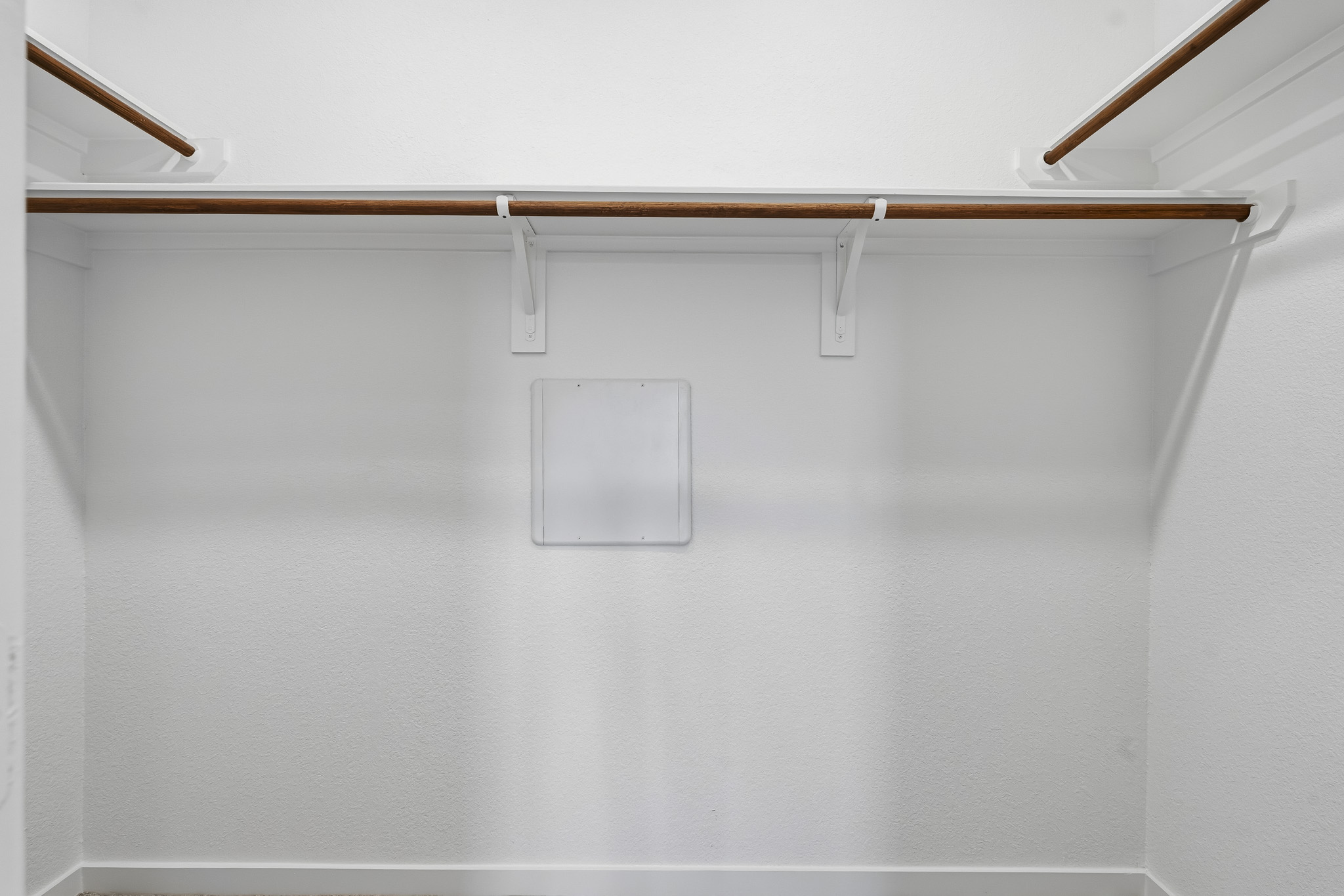A white wall with a light fixture.