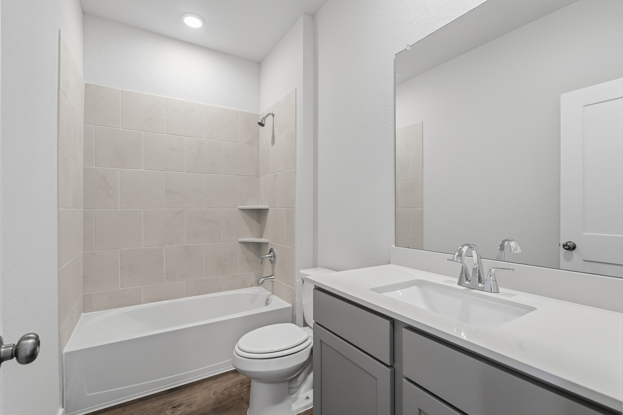 A bathroom with a tub sink and toilet.
