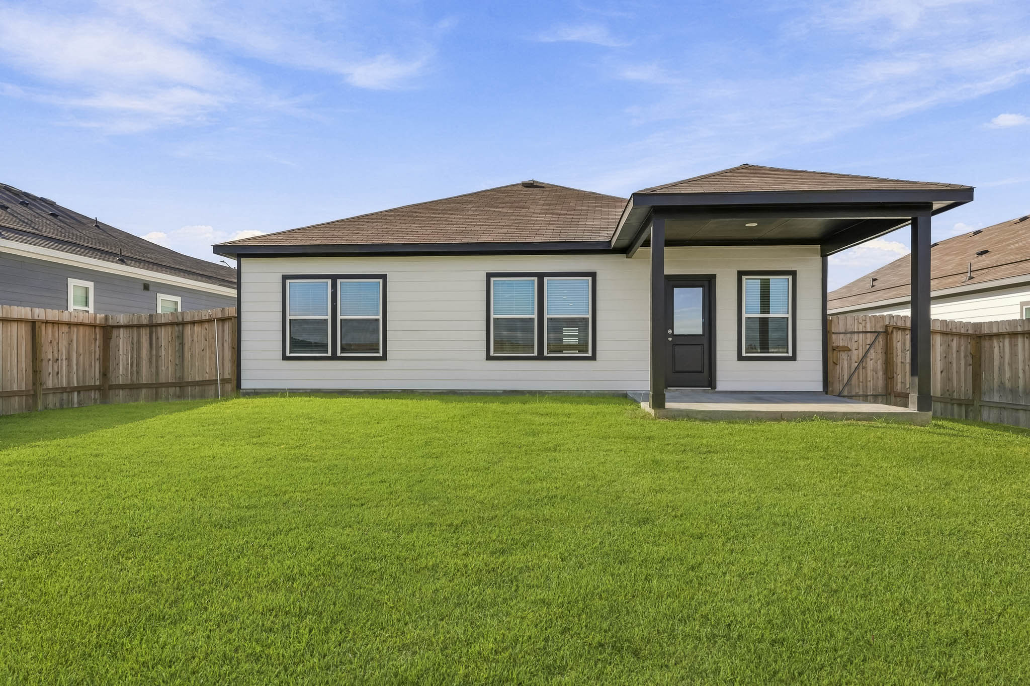 A house with a green lawn.
