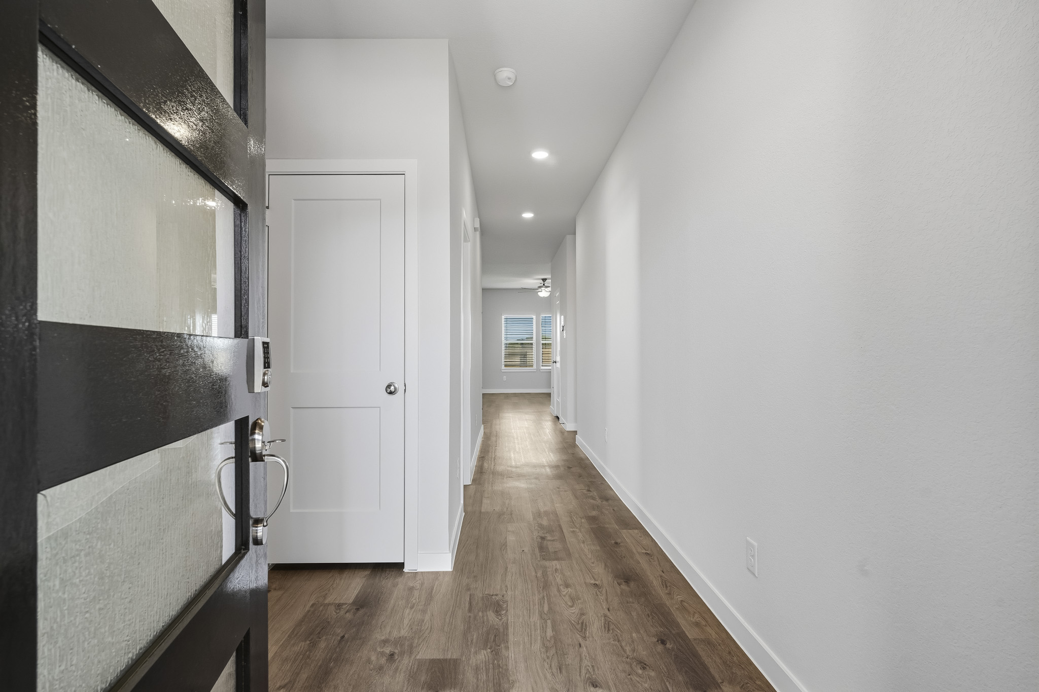 A hallway with white walls.