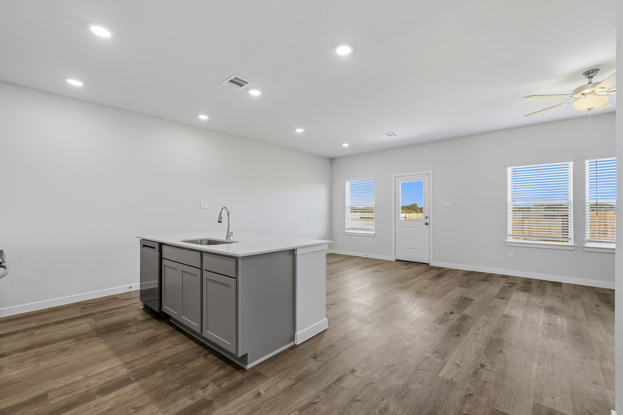 A kitchen with a wood floor.