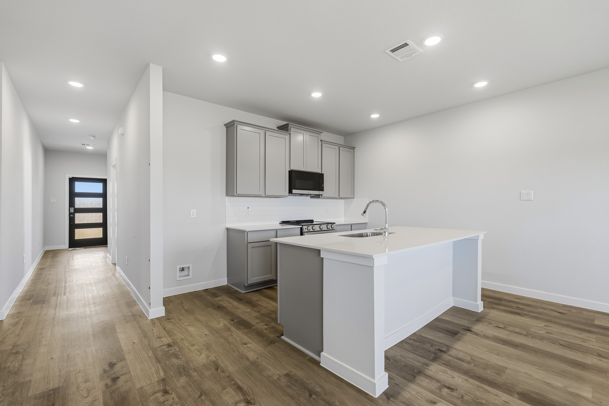 A kitchen with white cabinets.