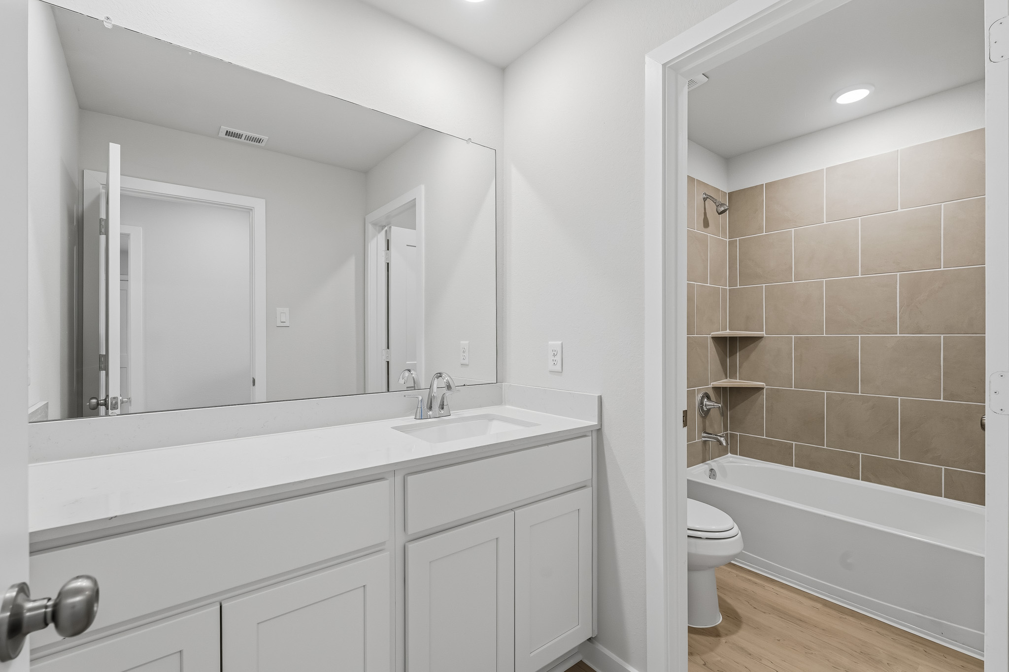 A bathroom with a tub sink and toilet.