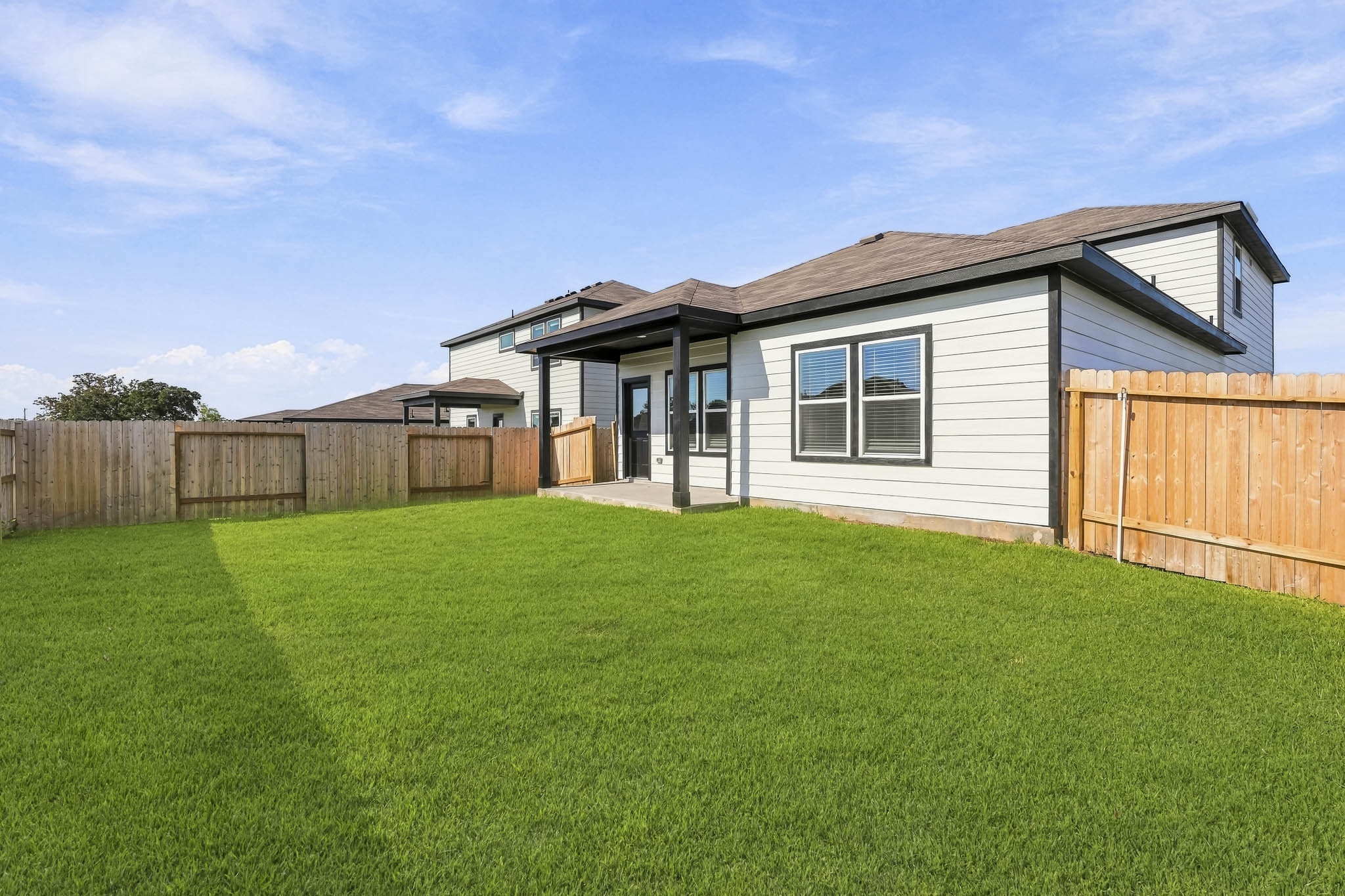 A house with a fence and grass.