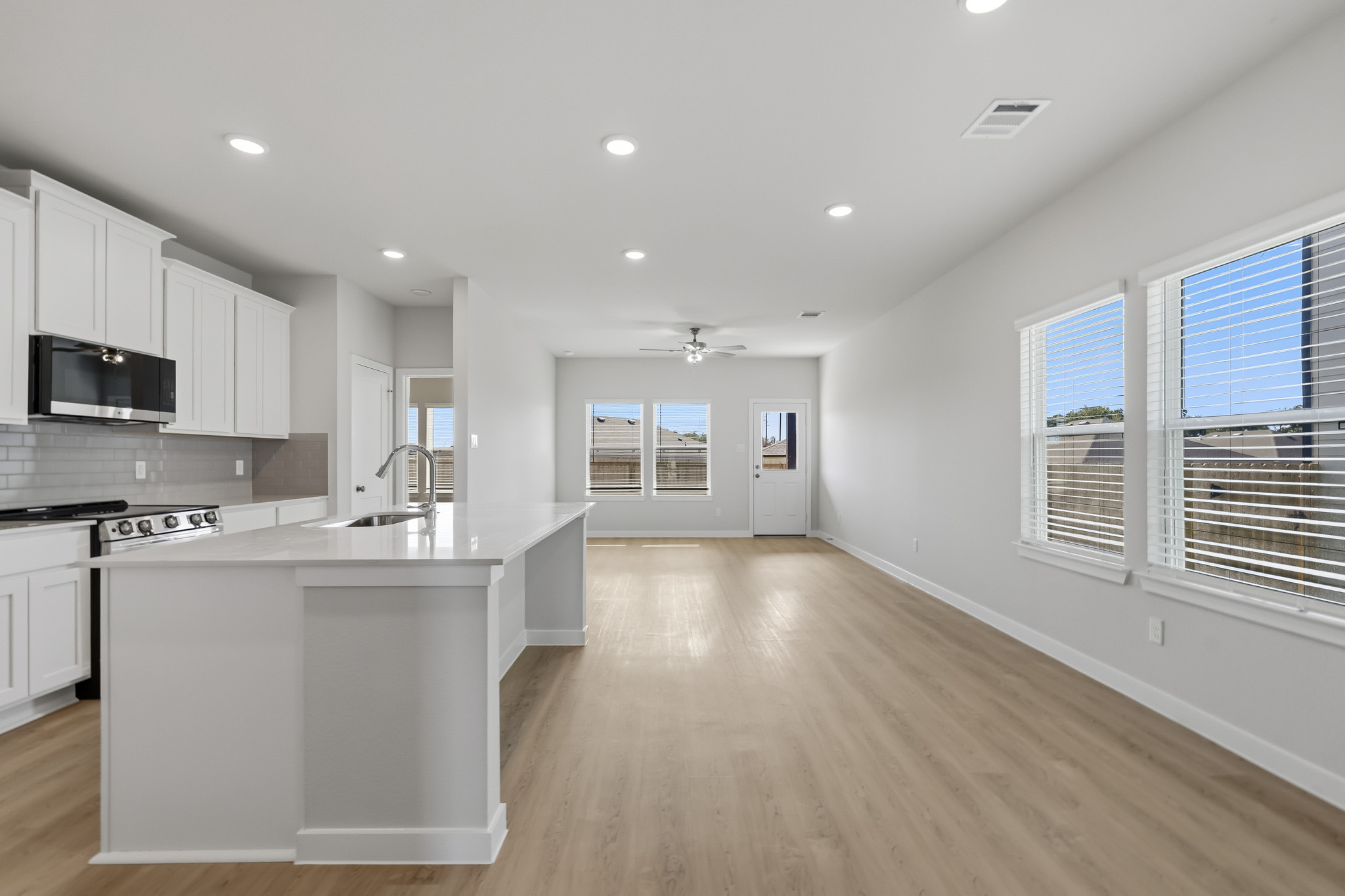 A kitchen with white cabinets.